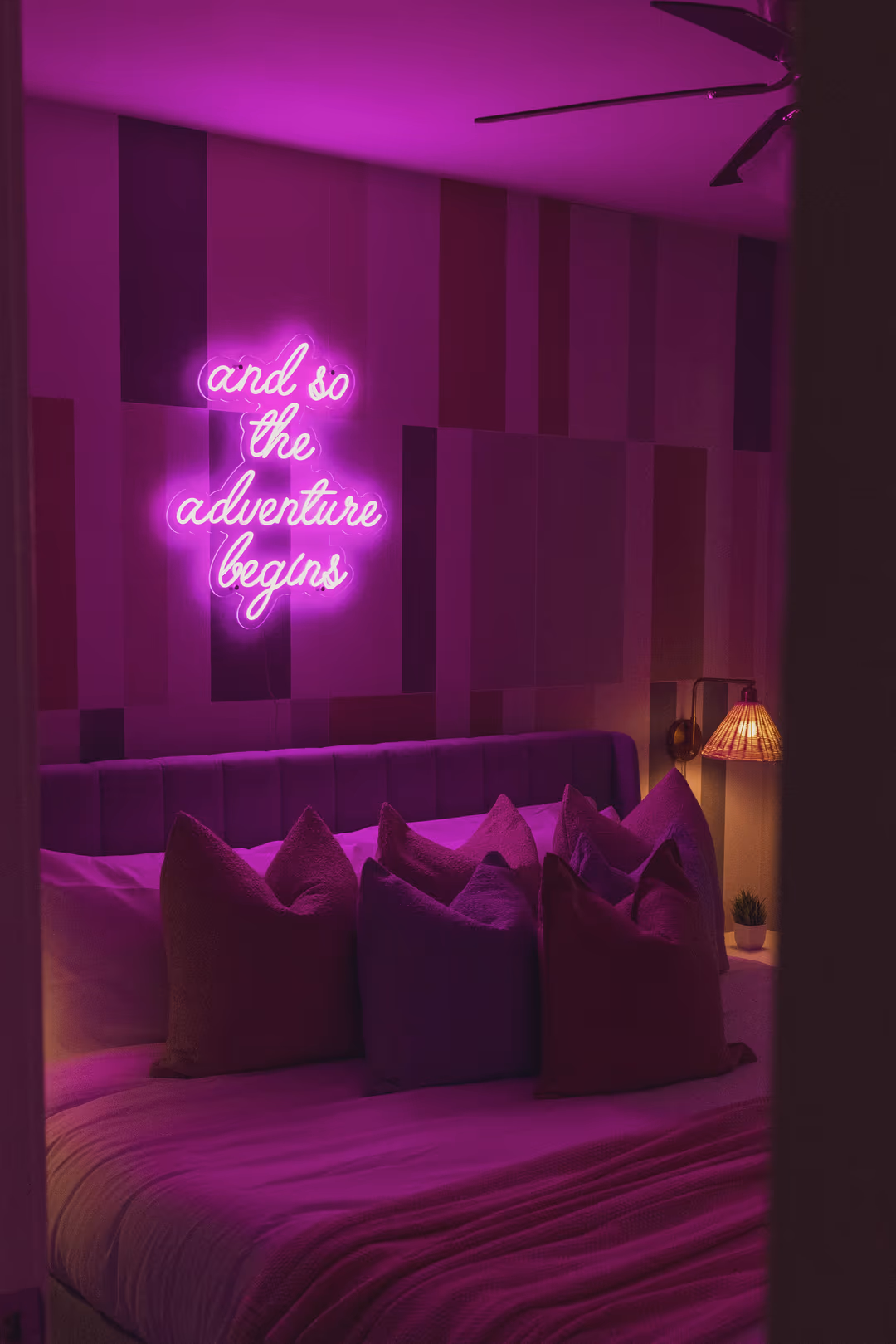 Designed short-term rental bedroom with neon accent